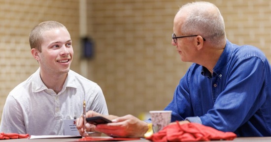 Swade Lamb (left), a sophomore international business major, speaks with a mentor during the Rural Fellows Academy inside the Nebraska East Union. Lamb will work with United Way of South Central Nebraska in Hastings. (Jordan Opp/University Communication and Marketing)